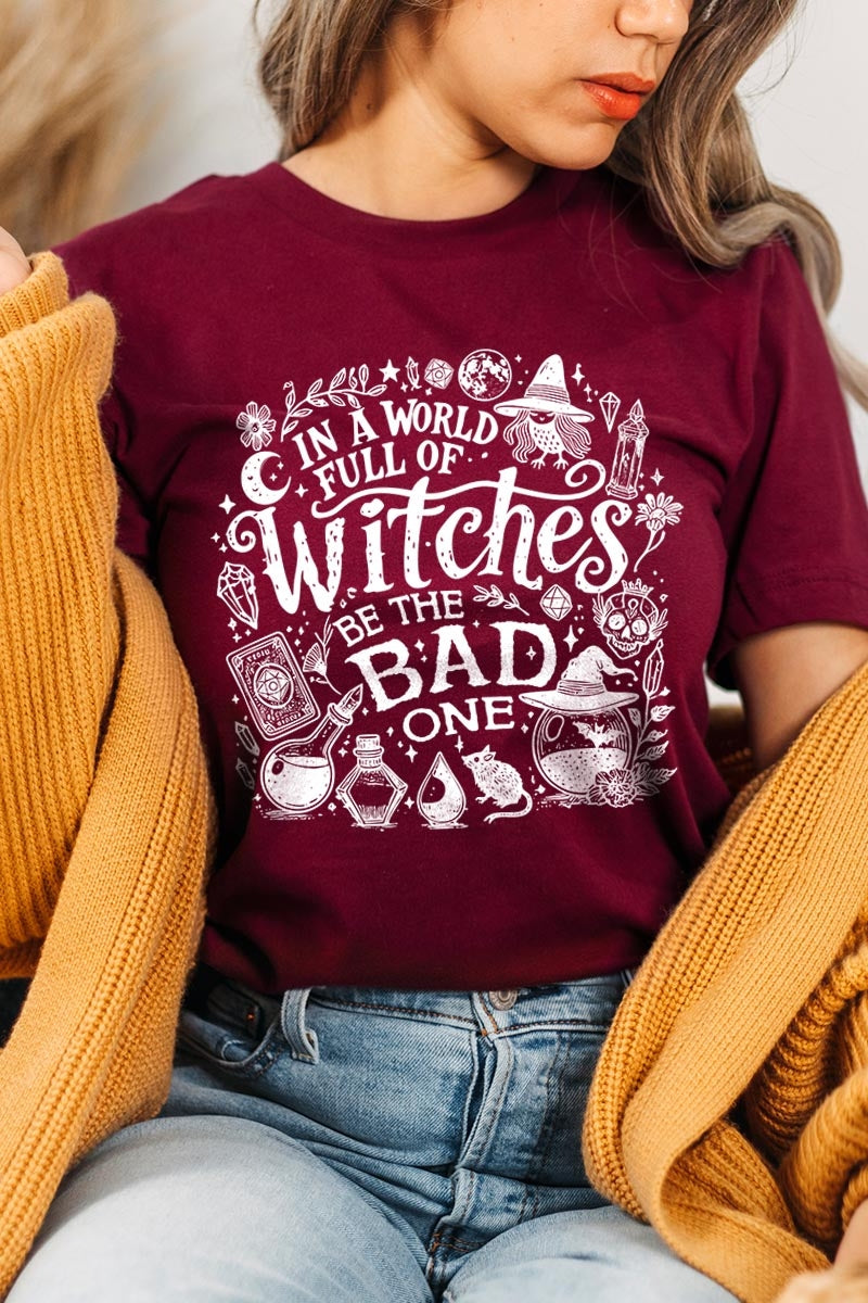 US3001-E3139 In a World of Witches Graphic Tee $12.5