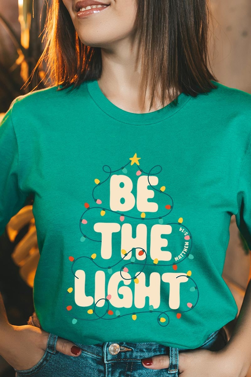 US3001P-E3202 Be the Light Christmas Graphic Plus Tee $16