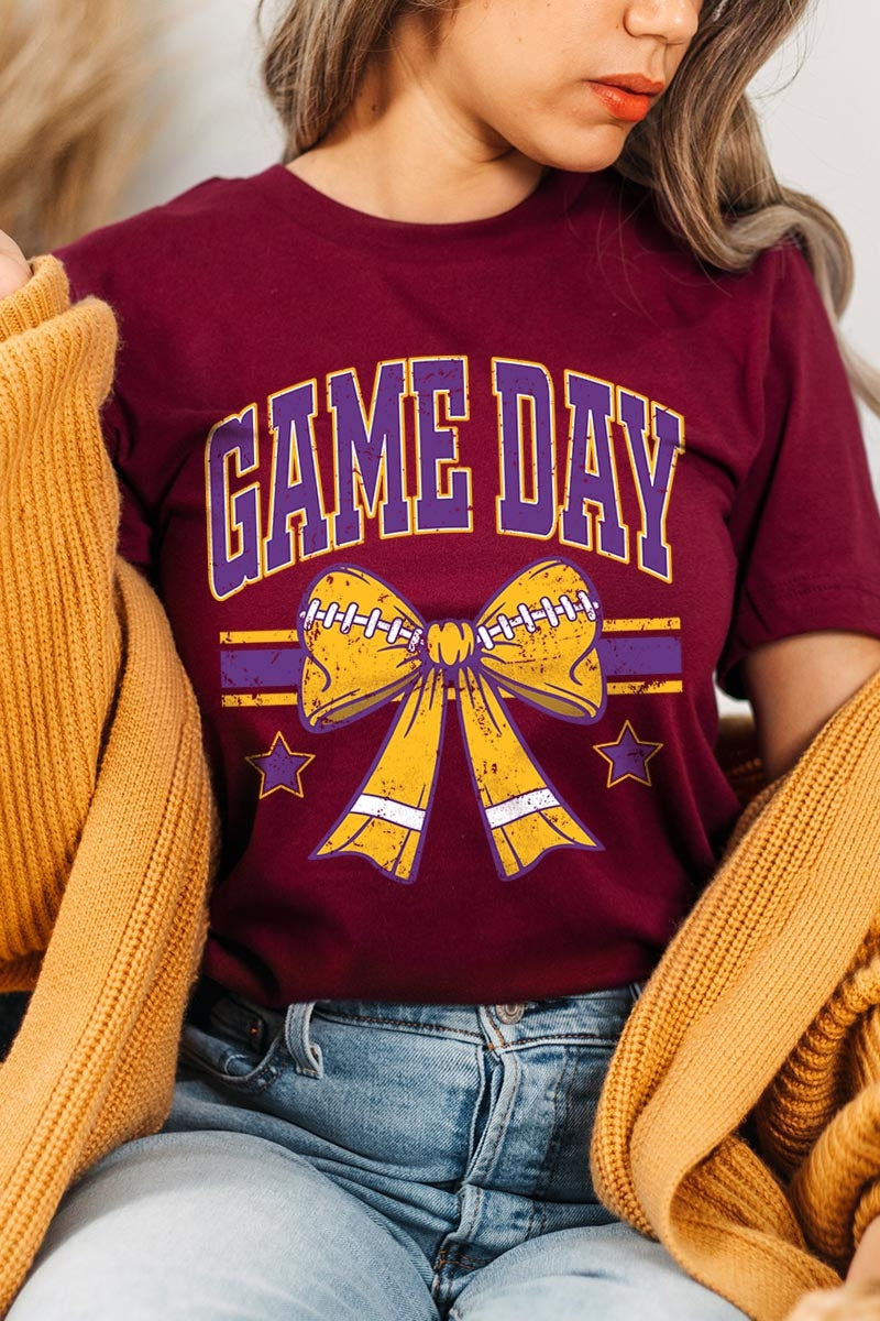 US3001-E3063 Purple Game Day Football Bow Graphic Tee $12.5