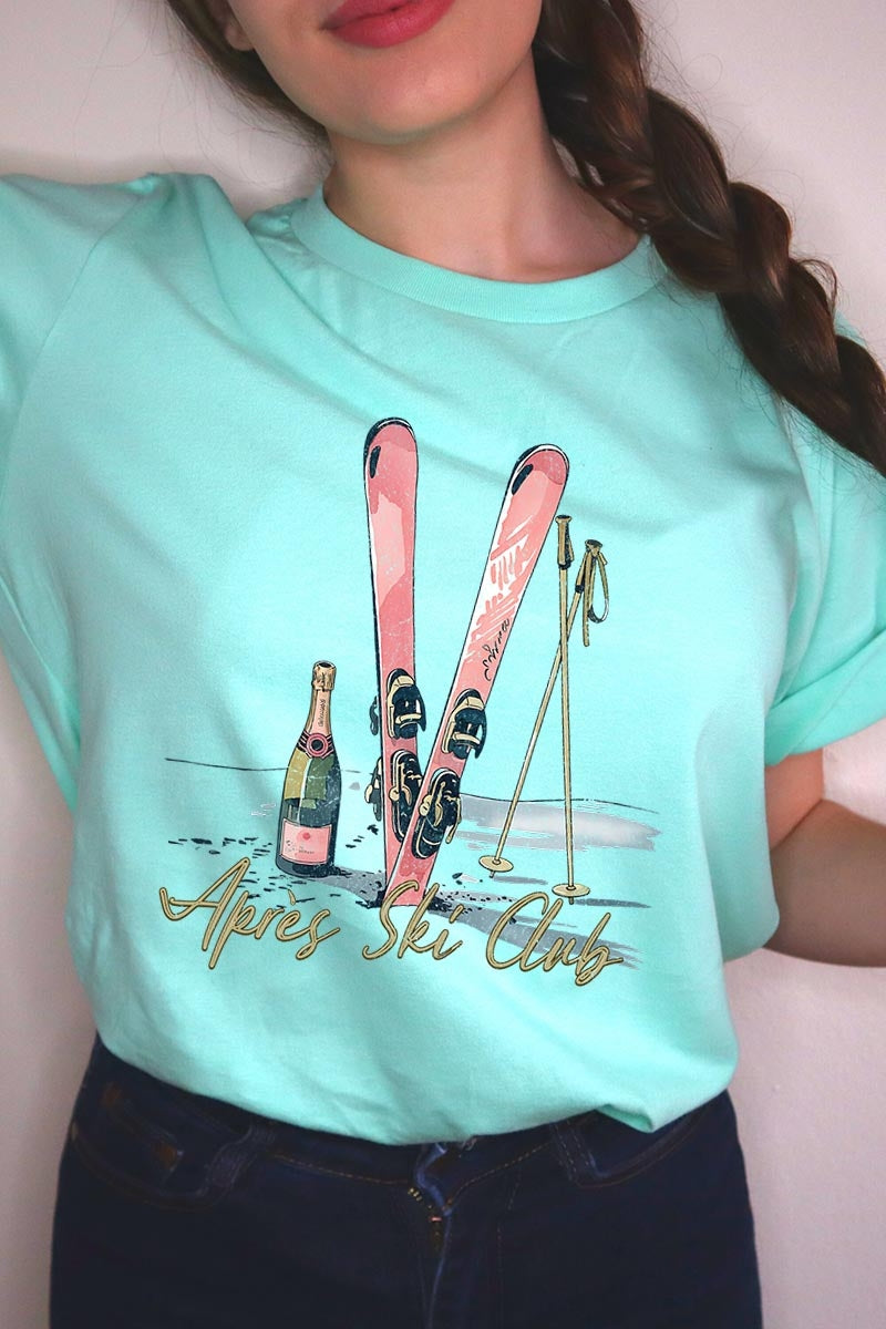 US3001P-E3187 Apres Ski Club Graphic Plus Tee $16